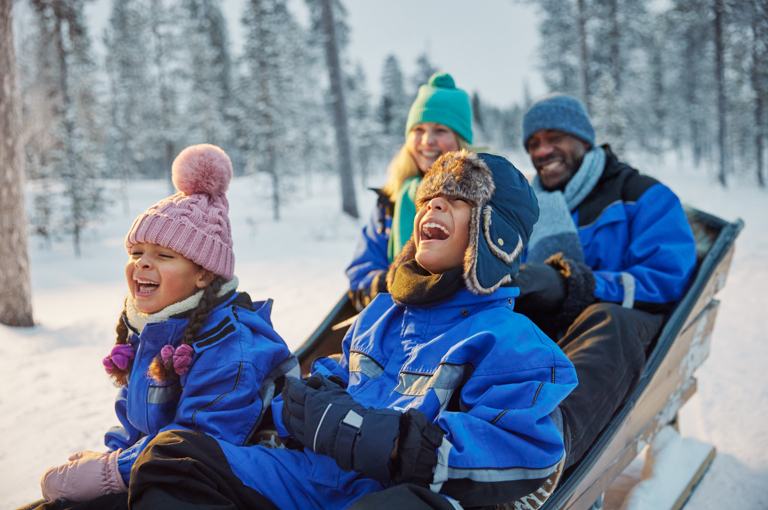 Family enjoying a Santa’s Magic Lapland short break in the snow