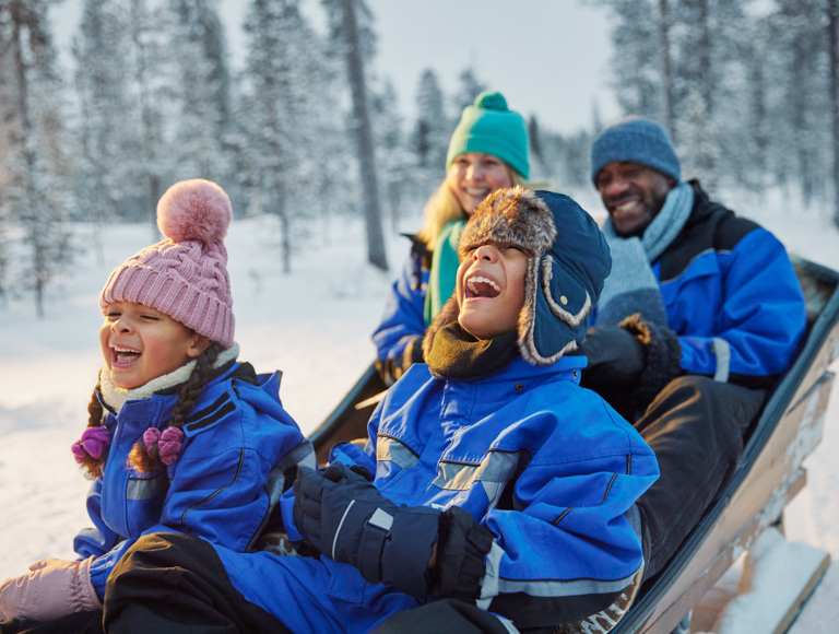 Family enjoying a Santa’s Magic Lapland short break in the snow