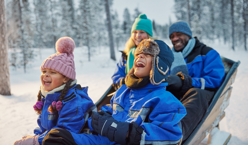 family laughing together in snow