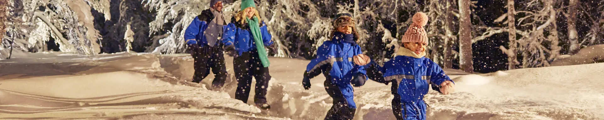 family running through the snow