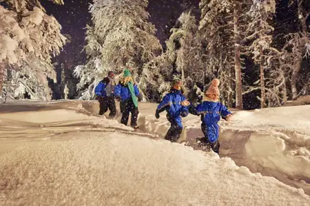family running through the snow