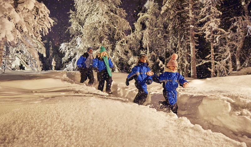 family running through the snow