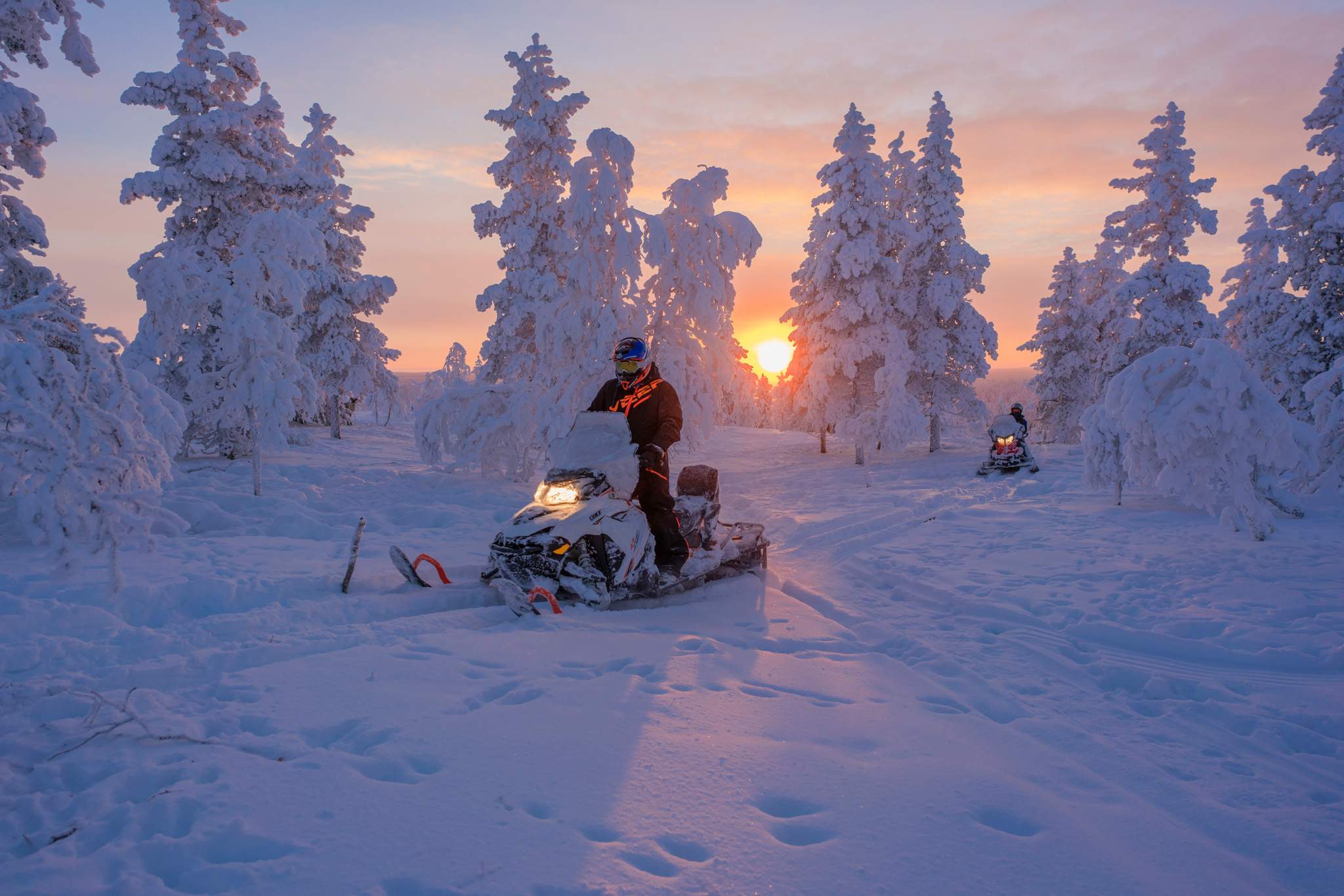 snowmobile ride at sunset