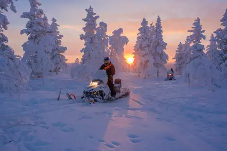 snowmobile ride at sunset