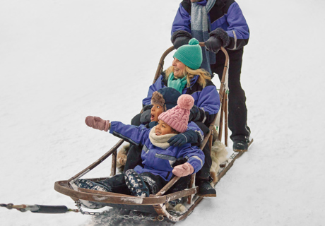 family pointing on sleigh