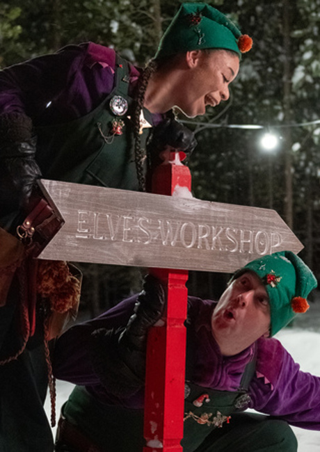 Santa’s Lapland elves showing the way to the Elves’ Workshop during a family trip to Lapland.